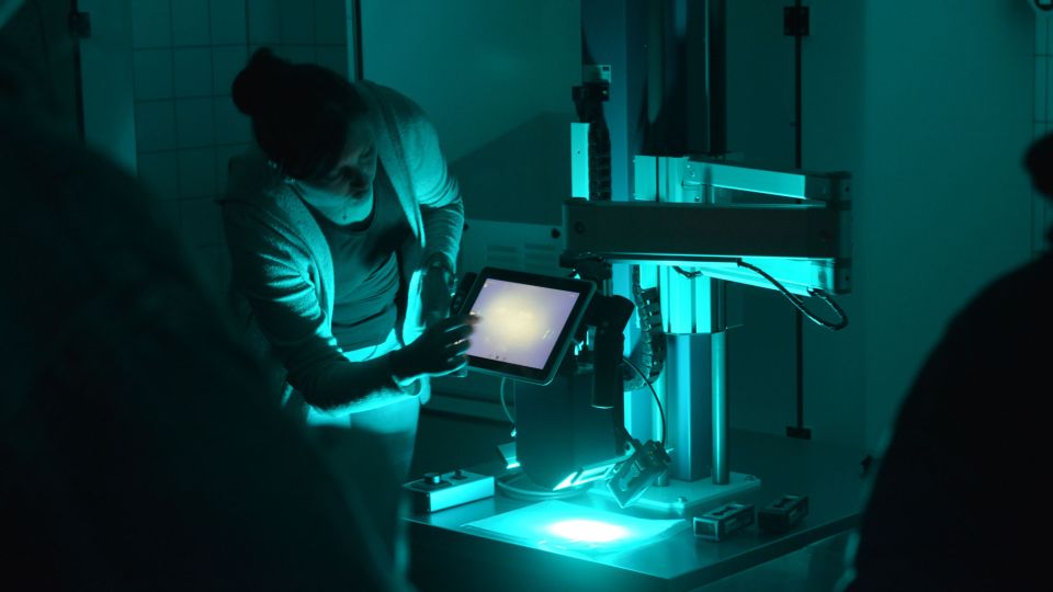 A police officer shows how ultraviolet light can be used to make traces visible on fabrics such as T-shirts.
